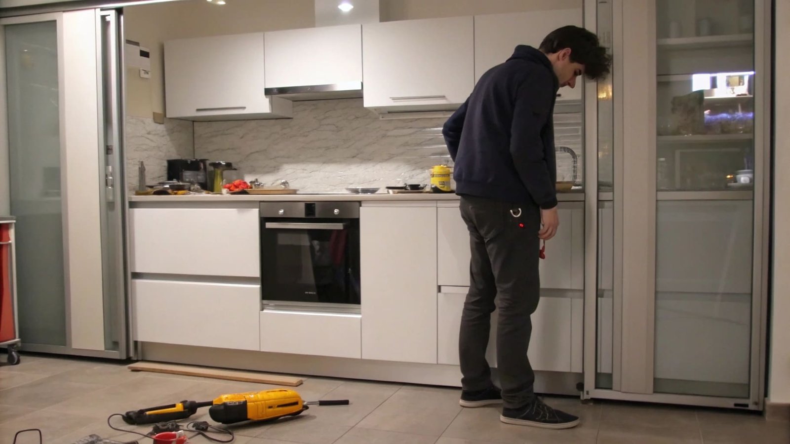 A person inspecting a sliding closet door track