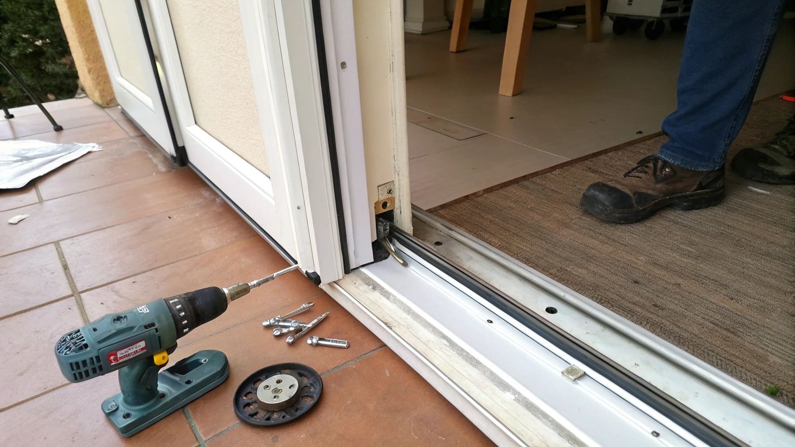 A close-up of a new sliding door pulley assembly ready for installation.