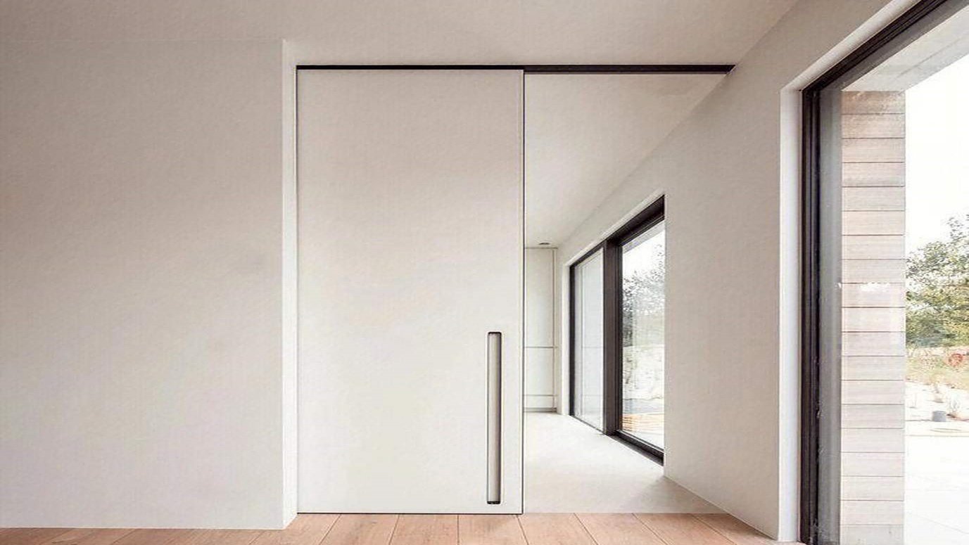 A level being used on a pocket door track during installation