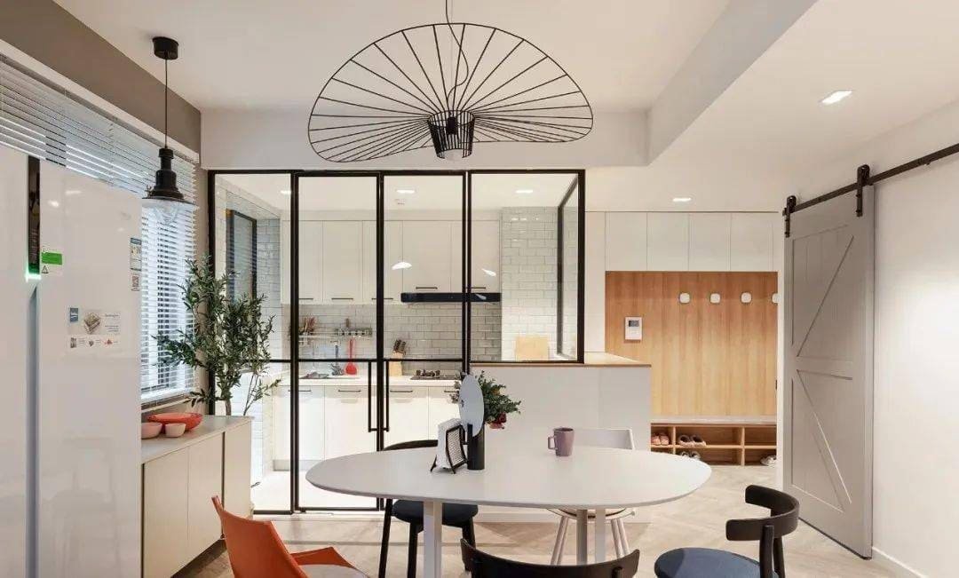 A real estate agent showing a home with a stylish sliding barn door feature.