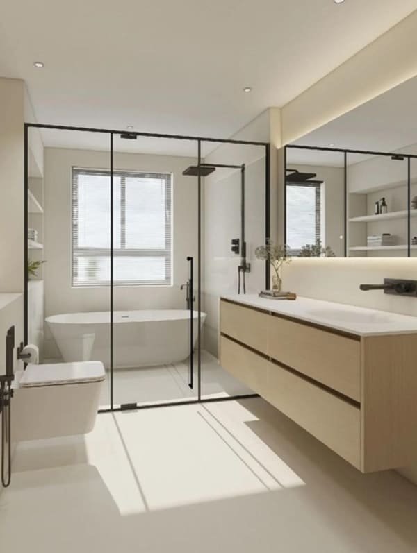 A small modern bathroom with a glass shower partition separating the wet and dry areas