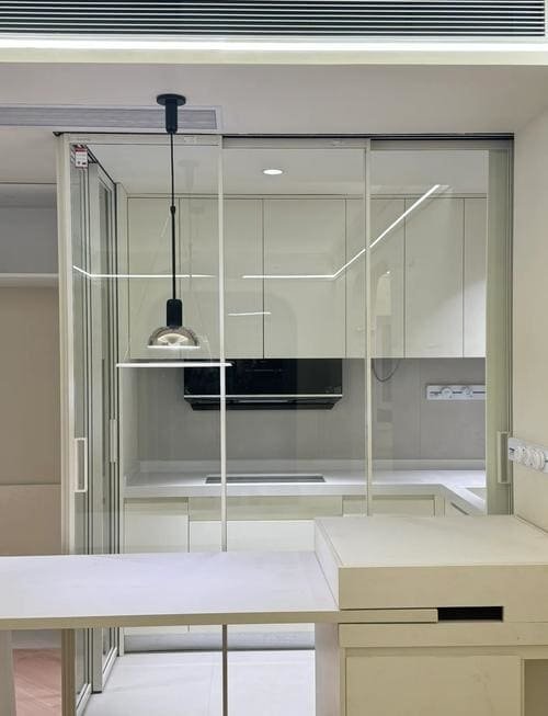 A sliding door system creating a large opening between two rooms