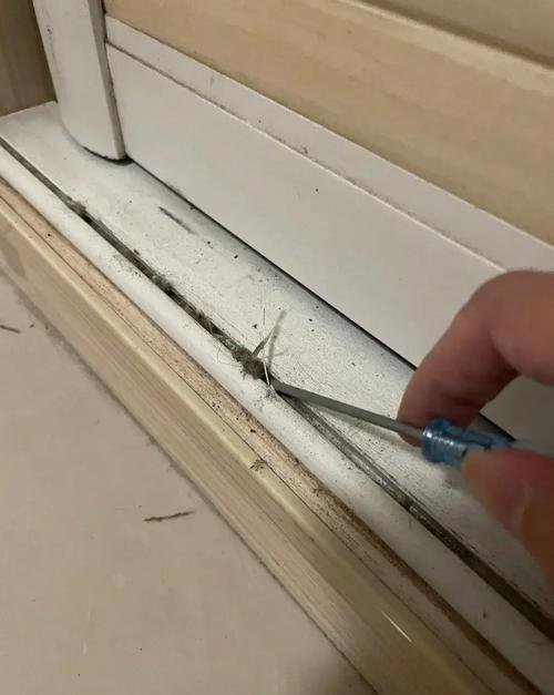 Close-up of a sliding door track that needs cleaning.