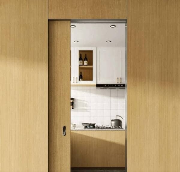 Close-up shot of high-quality rollers on a metal track for a pocket door.