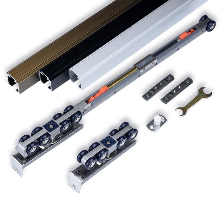 A person installing a retrofit soft-close kit onto a sliding door track