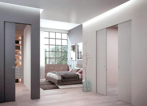 An open-concept home where a pocket door separates the kitchen from the living area.