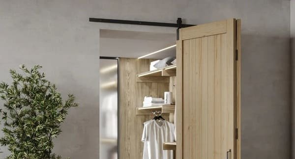 Two black double folding barn doors on a closet