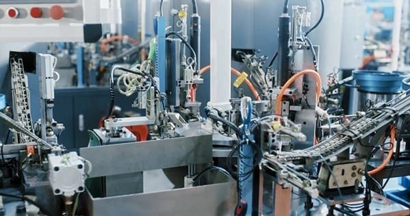 A futuristic image of a smart factory with data overlays showing efficiency metrics