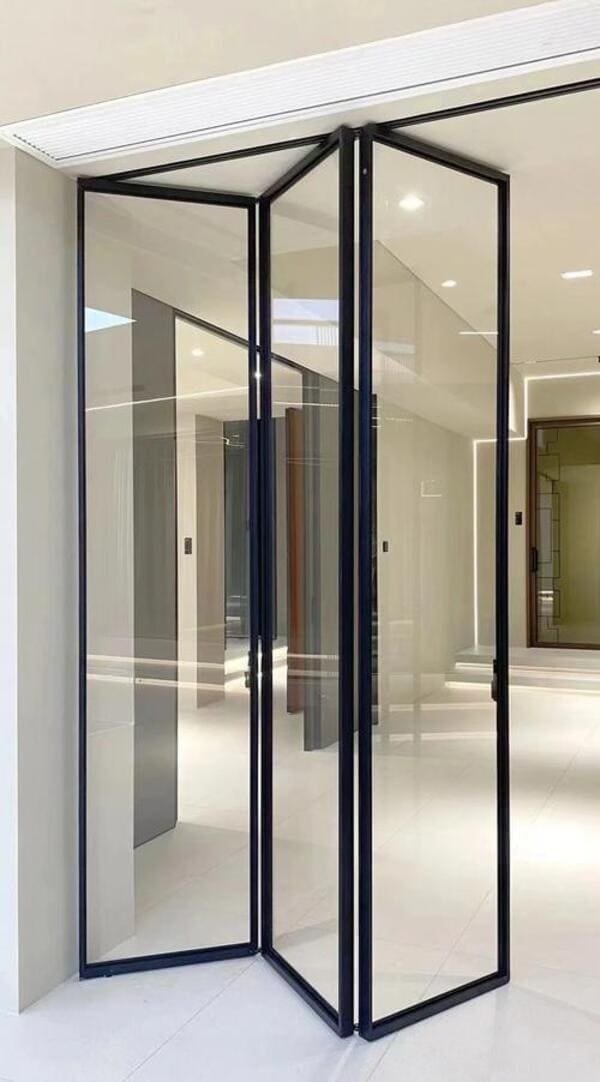 A modern living room with glass bi-folding doors open to a garden