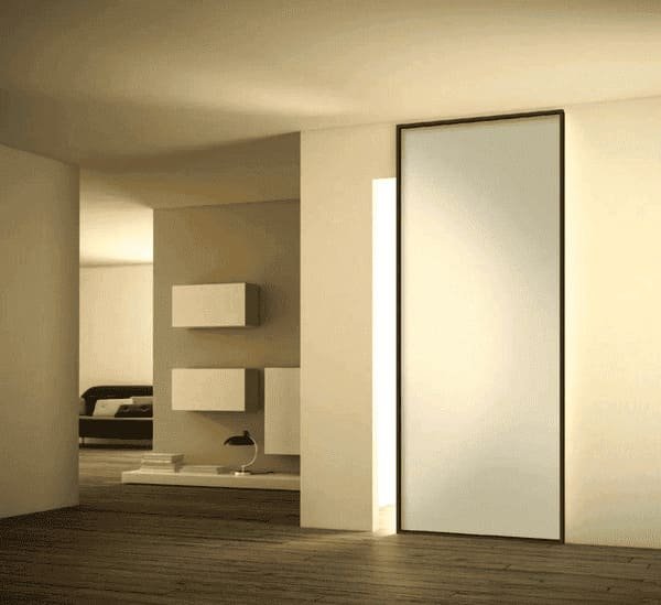 A sliding door installed as an entrance to a small, modern bathroom