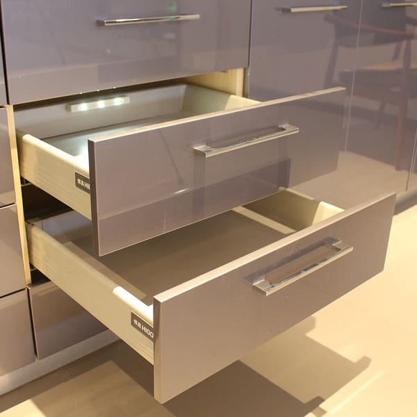 An LED strip light being pressed into an aluminum channel with a diffuser cover.