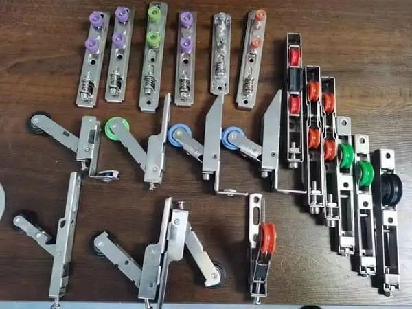 An assortment of nylon, steel, and stainless steel screen door rollers