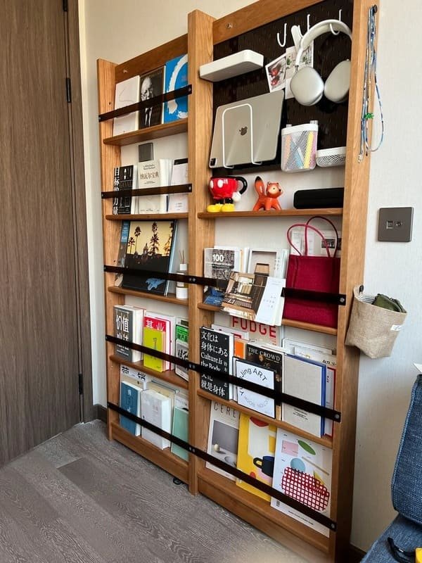 An over-the-door organizer holding shoes on the back of a closet door
