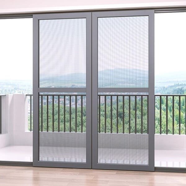 A homeowner enjoying the breeze through their new patio screen door