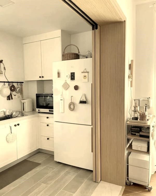 A large bookshelf that is also a secret door, slightly ajar to show a room behind it