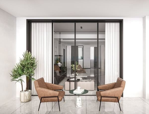 An assortment of sliding door rollers and hardware on a workshop table.