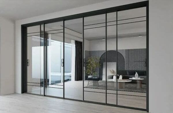 A modern living room with large glass sliding doors opening to a patio