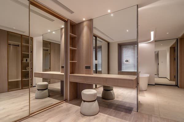 A large mirror reflecting a window in a small living room