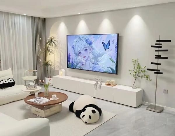 A flat-screen TV mounted on the wall above a slim console