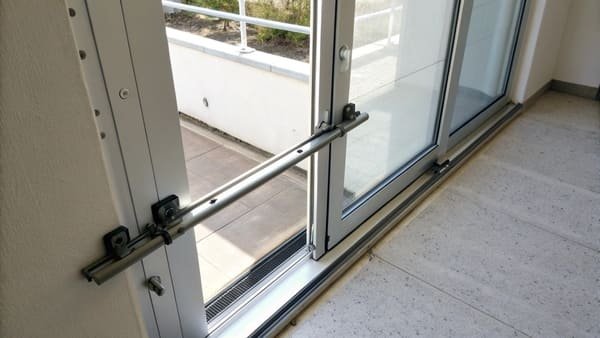 a security bar firmly placed in the track of a sliding glass door